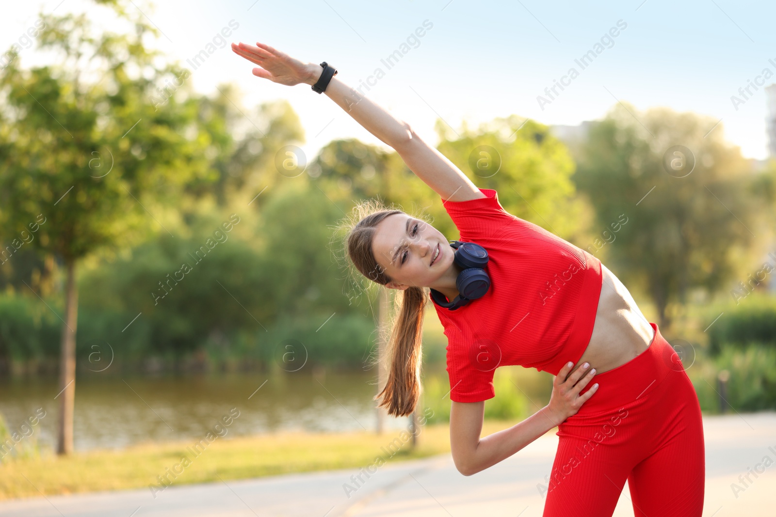 Photo of Happy sportswoman doing morning exercise outdoors. Healthy lifestyle