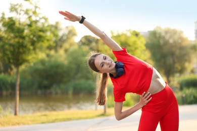 Photo of Happy sportswoman doing morning exercise outdoors. Healthy lifestyle