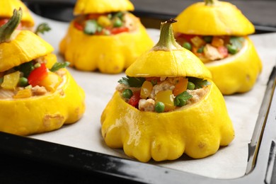 Photo of Tasty stuffed pattypan squashes on baking sheet, closeup