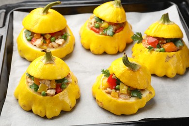 Photo of Tasty stuffed pattypan squashes on baking sheet, closeup