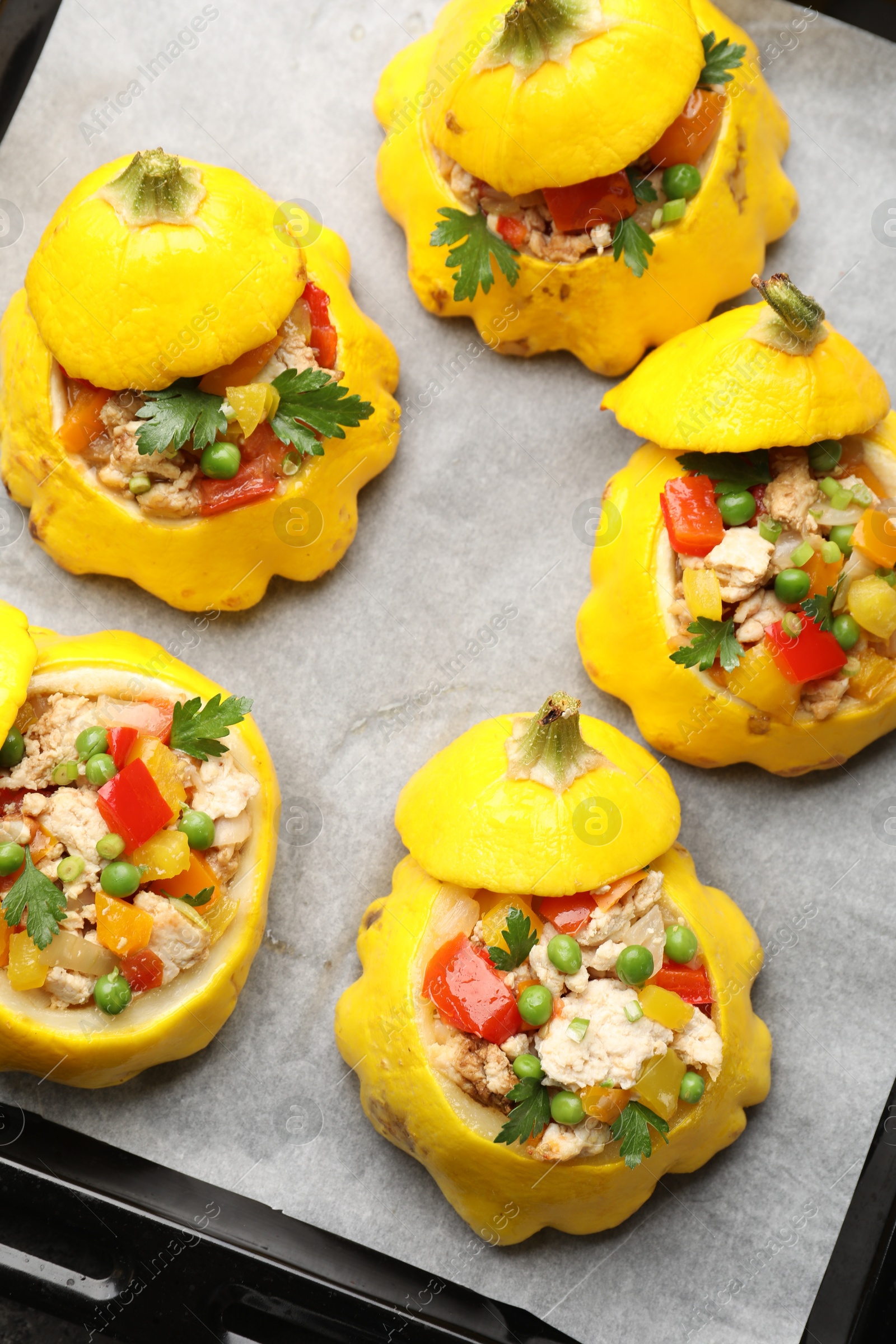Photo of Tasty stuffed pattypan squashes on baking sheet, top view