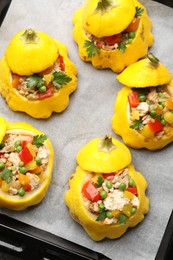 Photo of Tasty stuffed pattypan squashes on baking sheet, top view
