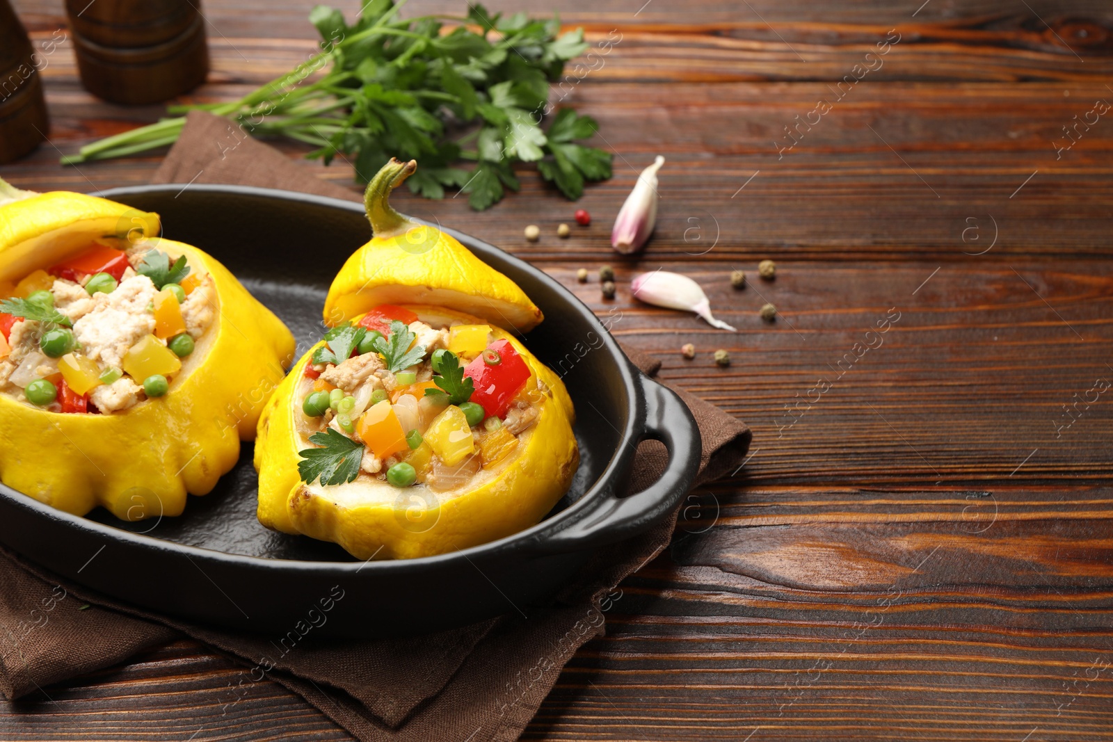 Tasty stuffed pattypan squashes in baking dish on wooden table, closeup. Space for text Photo of Tasty stuffed pattypan squashes in baking dish on wooden table, closeup. Space for text