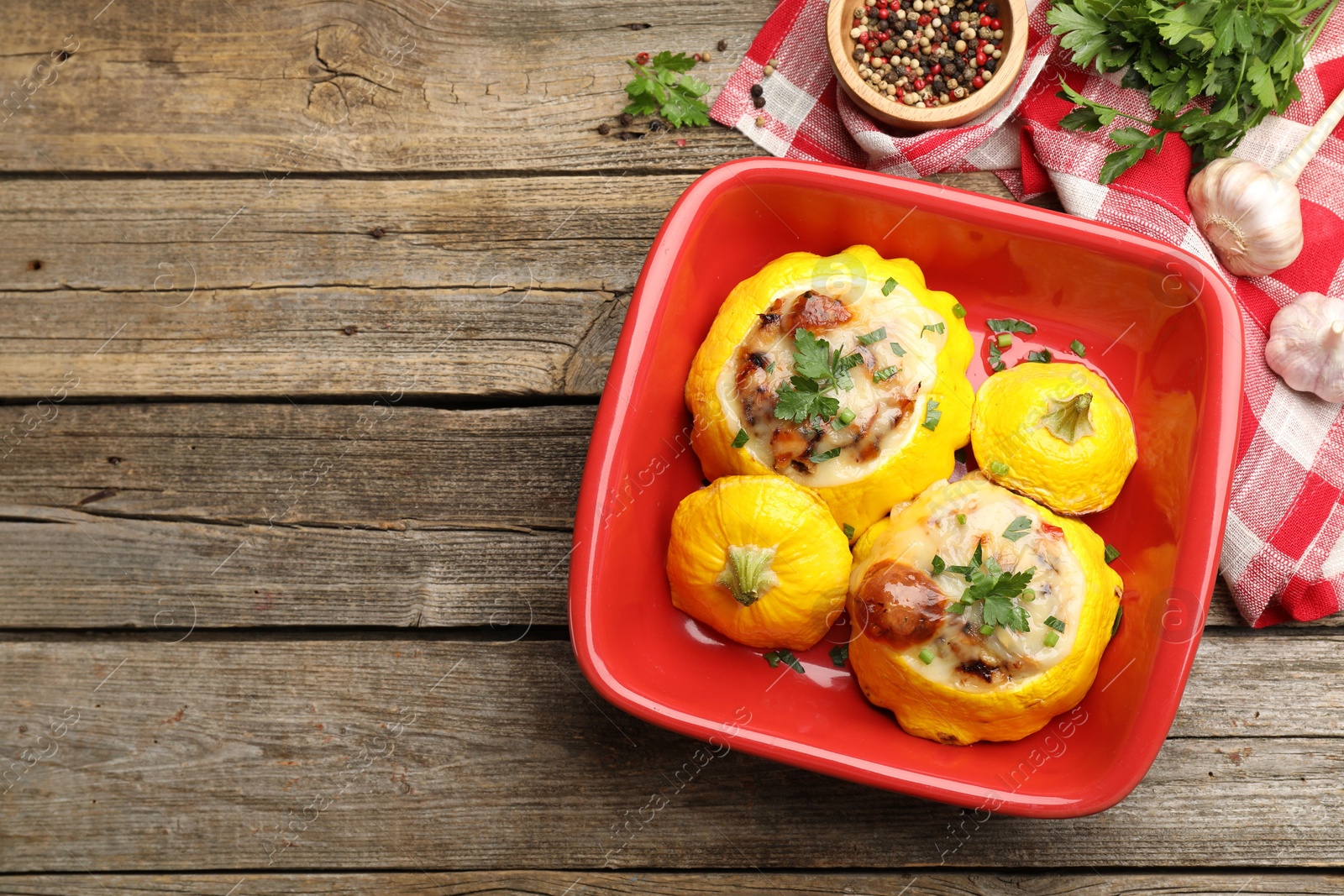 Tasty stuffed pattypan squashes in baking dish on wooden table, flat lay. Space for text Photo of Tasty stuffed pattypan squashes in baking dish on wooden table, flat lay. Space for text