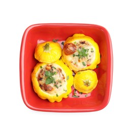 Photo of Tasty stuffed pattypan squashes in baking dish isolated on white, top view