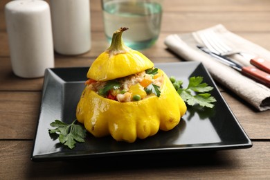 Photo of Tasty stuffed pattypan squash on wooden table, closeup