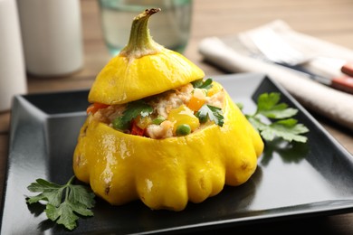 Photo of Tasty stuffed pattypan squash on wooden table, closeup