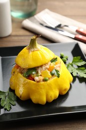 Photo of Tasty stuffed pattypan squash on wooden table, closeup