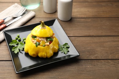 Photo of Tasty stuffed pattypan squash on wooden table, space for text