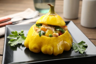 Photo of Tasty stuffed pattypan squash on wooden table, closeup