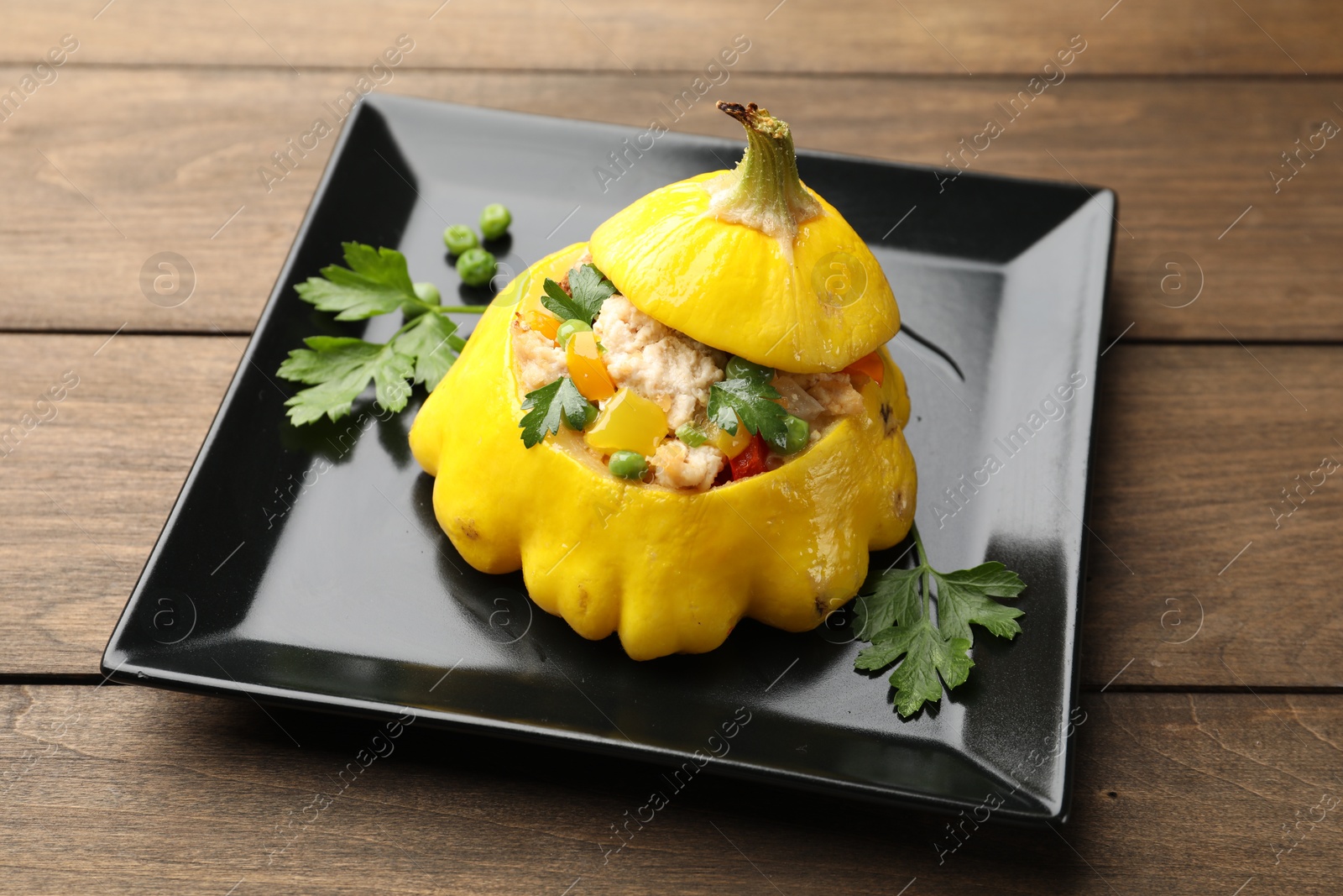 Tasty stuffed pattypan squash on wooden table, closeup Photo of Tasty stuffed pattypan squash on wooden table, closeup