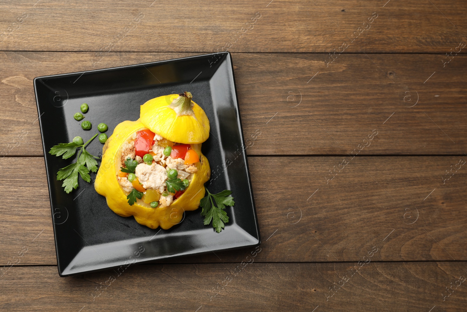 Tasty stuffed pattypan squash on wooden table, top view. Space for text Photo of Tasty stuffed pattypan squash on wooden table, top view. Space for text