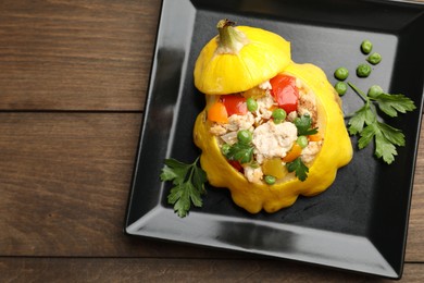 Photo of Tasty stuffed pattypan squash on wooden table, top view