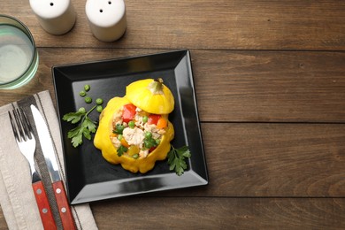 Photo of Tasty stuffed pattypan squash served on wooden table, flat lay. Space for text