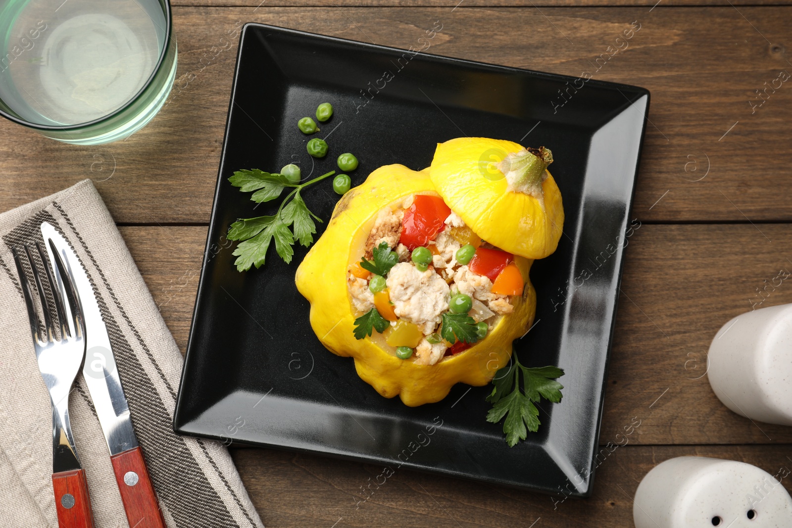 Tasty stuffed pattypan squash served on wooden table, flat lay Photo of Tasty stuffed pattypan squash served on wooden table, flat lay