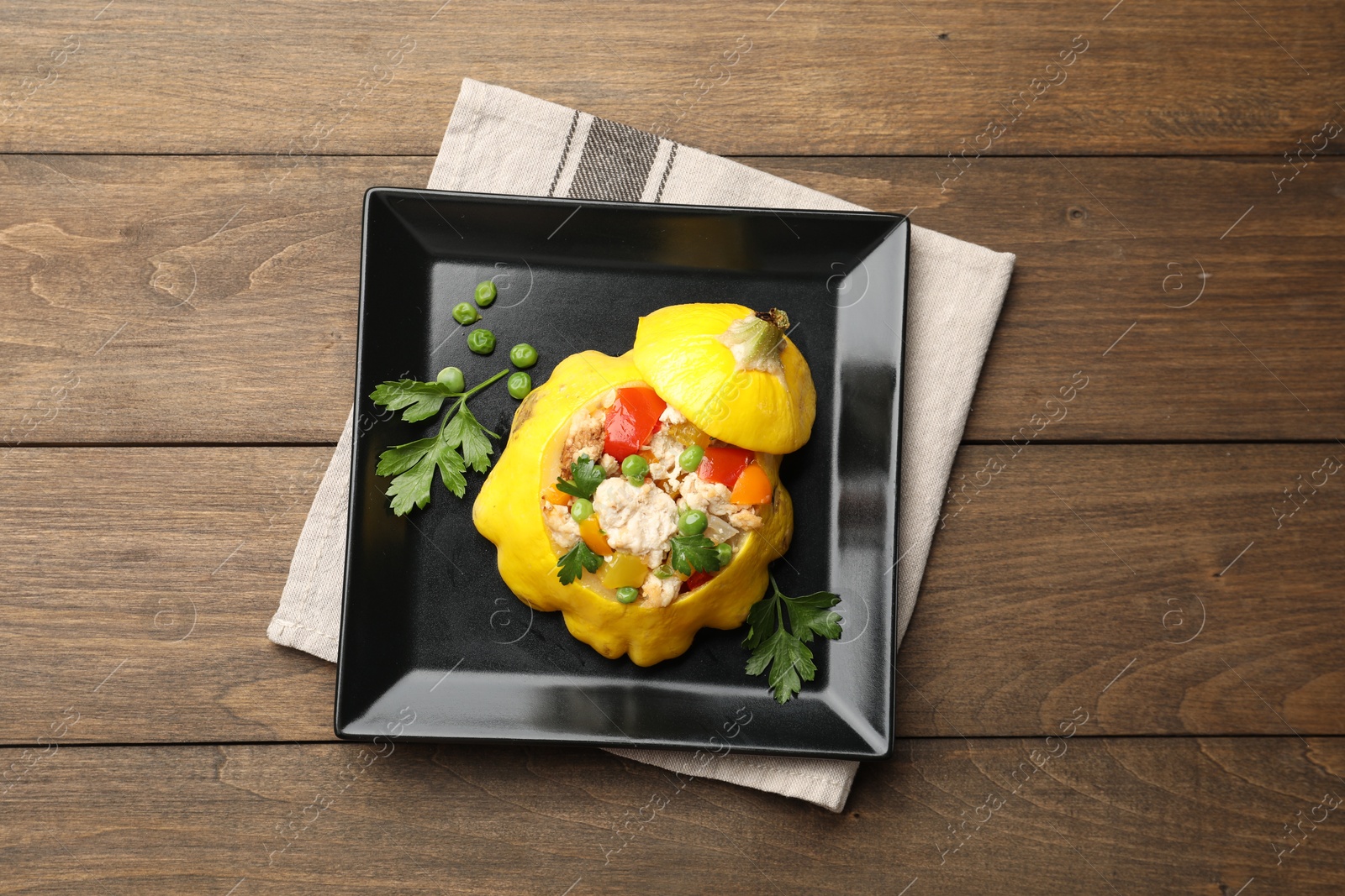Tasty stuffed pattypan squash on wooden table, top view Photo of Tasty stuffed pattypan squash on wooden table, top view