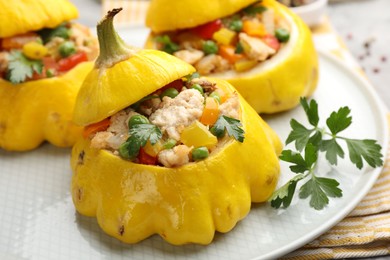 Photo of Tasty stuffed pattypan squashes on grey table, closeup