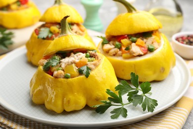 Photo of Tasty stuffed pattypan squashes on grey table, closeup
