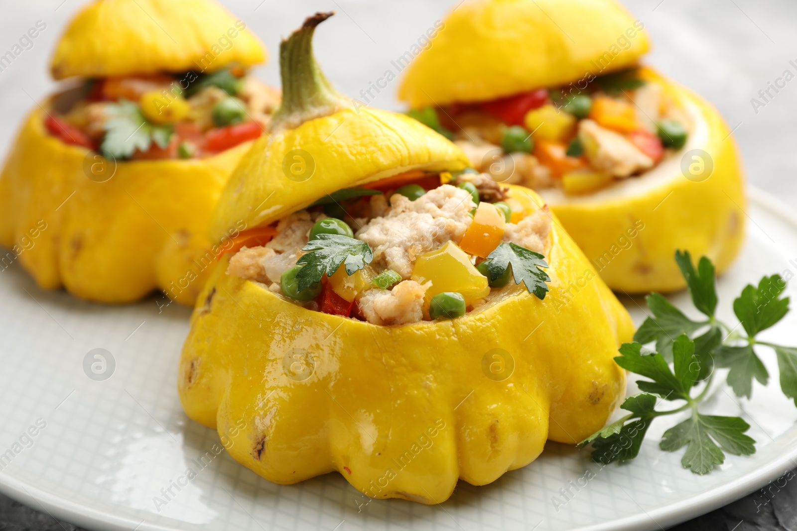 Tasty stuffed pattypan squashes on grey table, closeup Photo of Tasty stuffed pattypan squashes on grey table, closeup