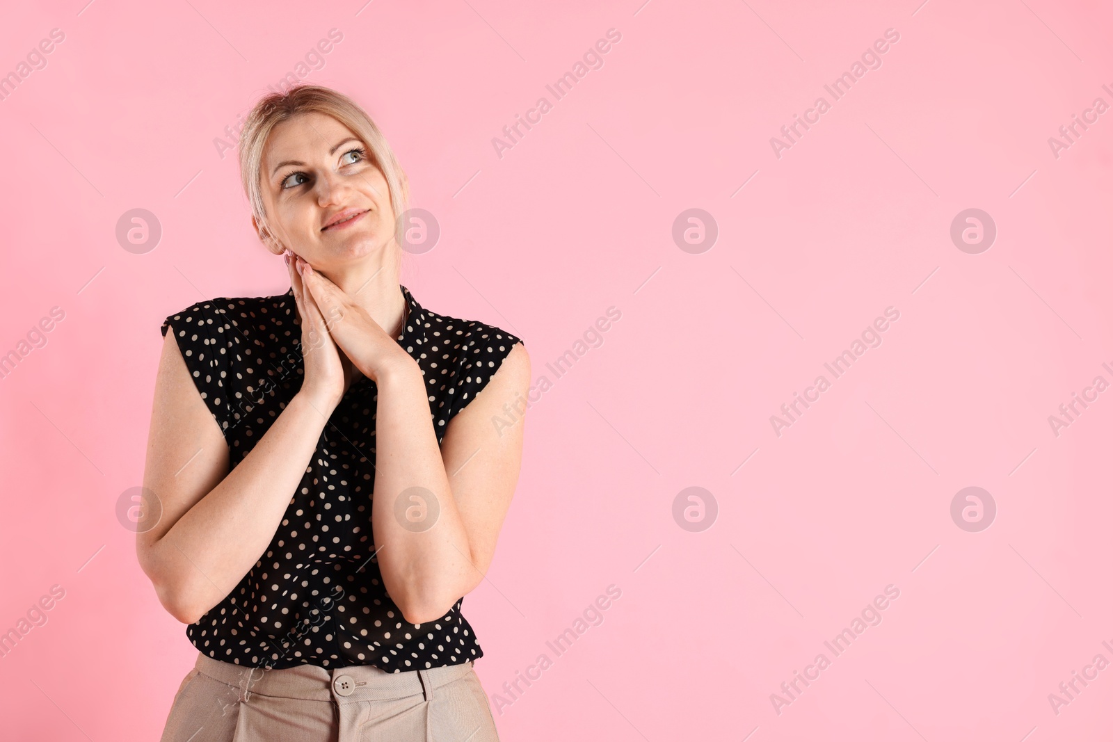 Dreams come true. Woman thinking about something on pink background, space for text Photo of Dreams come true. Woman thinking about something on pink background, space for text