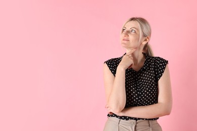 Photo of Dreams come true. Woman thinking about something on pink background, space for text