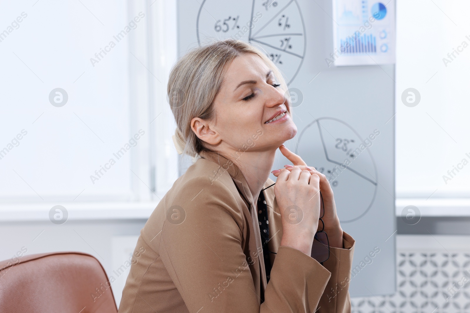 Dreams come true. Happy woman thinking about something indoors Photo of Dreams come true. Happy woman thinking about something indoors