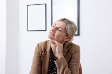 Photo of Dreams come true. Happy woman thinking about something indoors