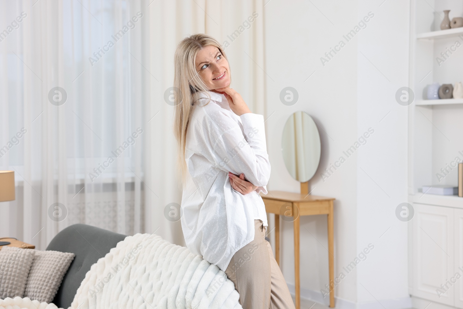 Dreams come true. Woman thinking about something at home Photo of Dreams come true. Woman thinking about something at home