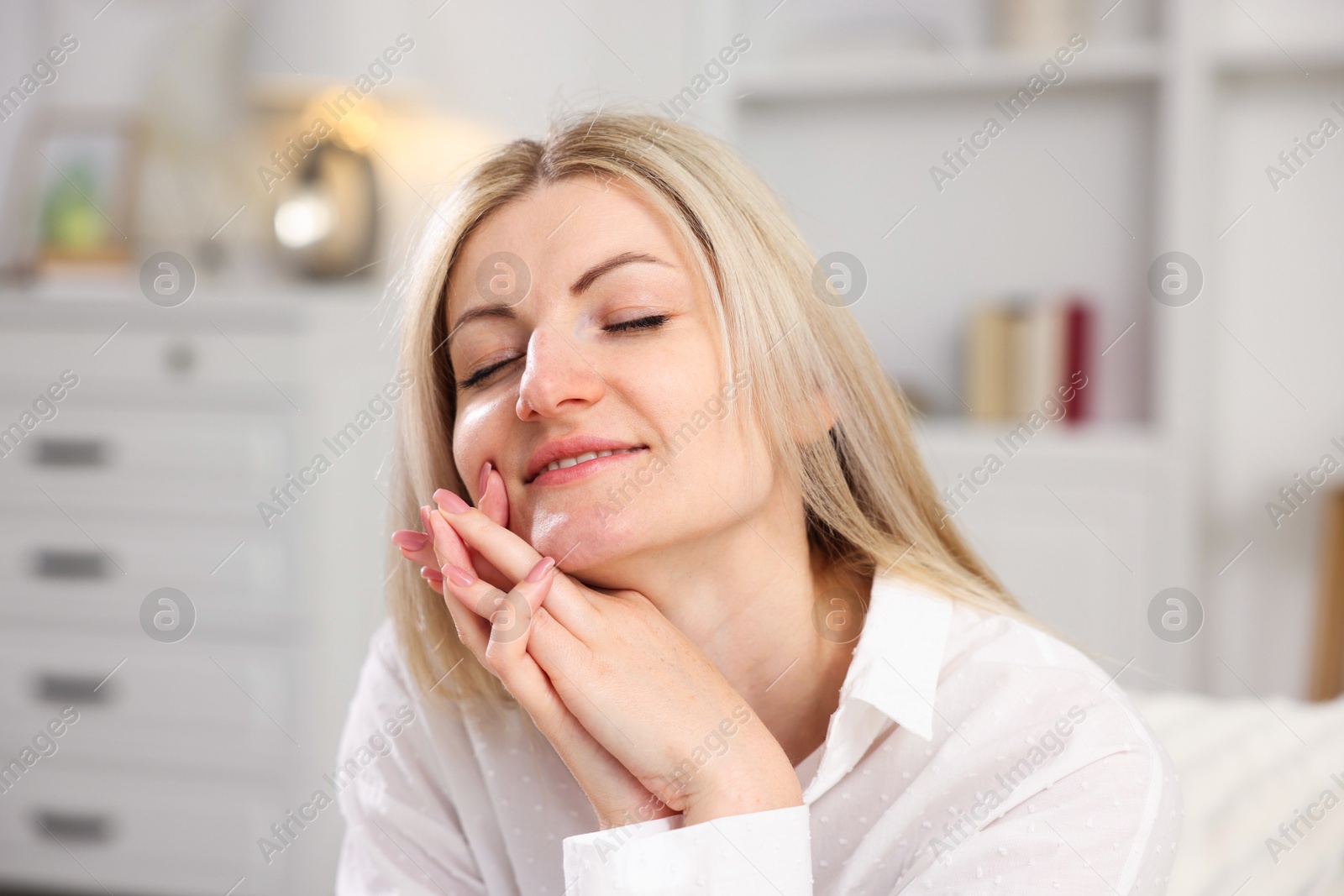 Dreams come true. Woman thinking about something at home Photo of Dreams come true. Woman thinking about something at home