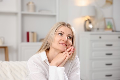 Photo of Dreams come true. Woman thinking about something at home
