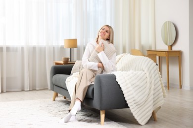Photo of Dreams come true. Woman with pillow thinking about something on sofa at home