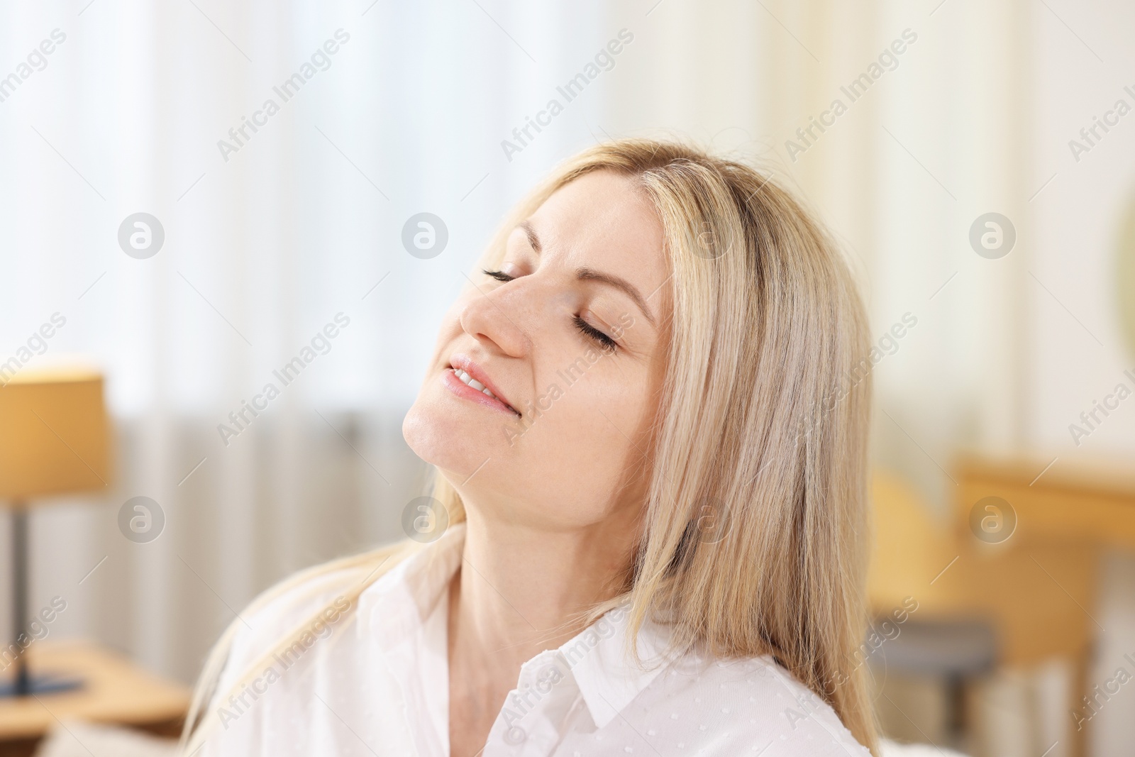 Dreams come true. Woman thinking about something at home Photo of Dreams come true. Woman thinking about something at home