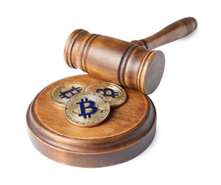 Photo of Cryptocurrency. Bitcoins and judge's gavel isolated on white