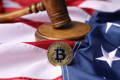 Photo of Cryptocurrency. Bitcoin and judge's gavel on American flag, closeup