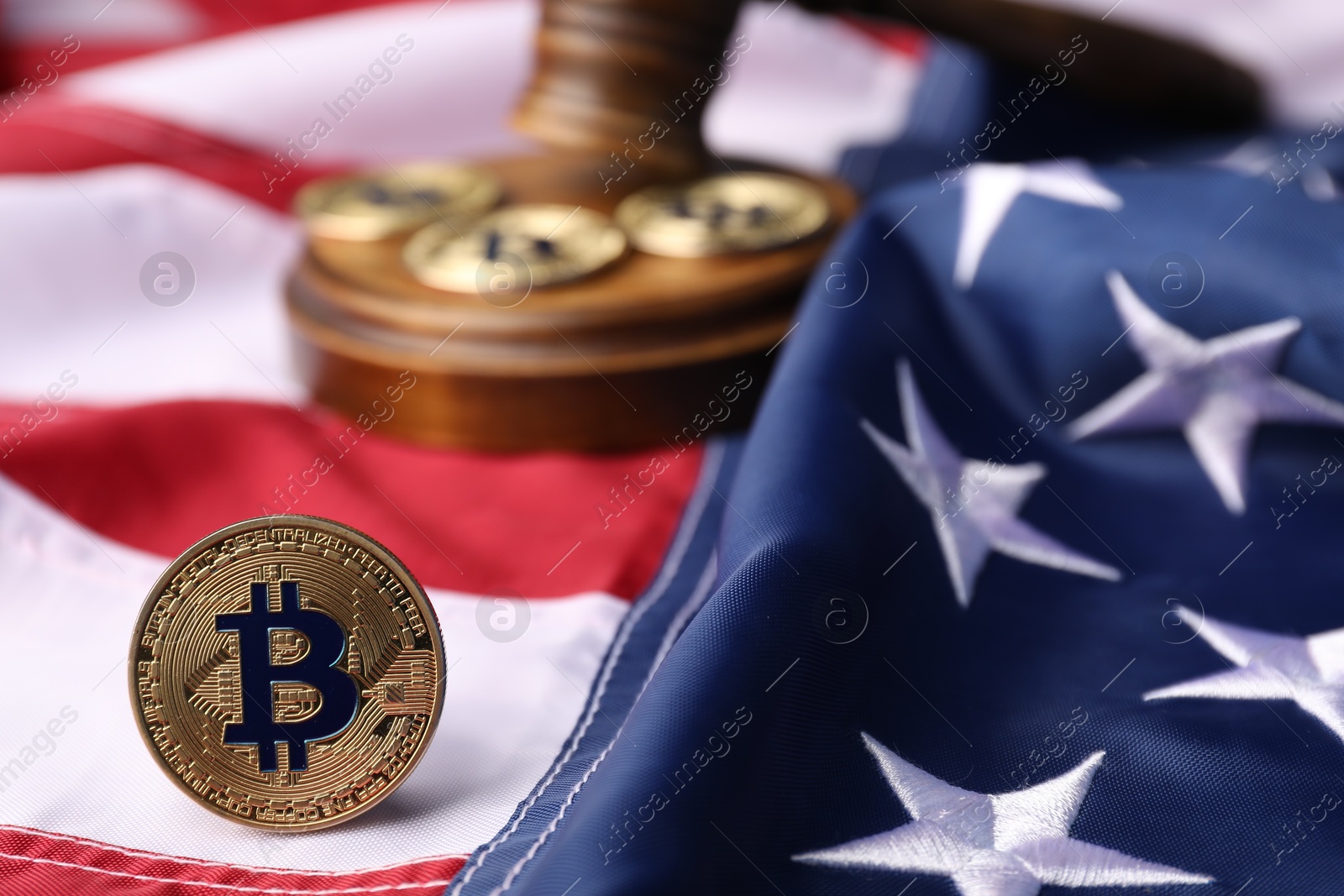 Cryptocurrency. Bitcoins and judge's gavel on American flag, closeup Photo of Cryptocurrency. Bitcoins and judge's gavel on American flag, closeup