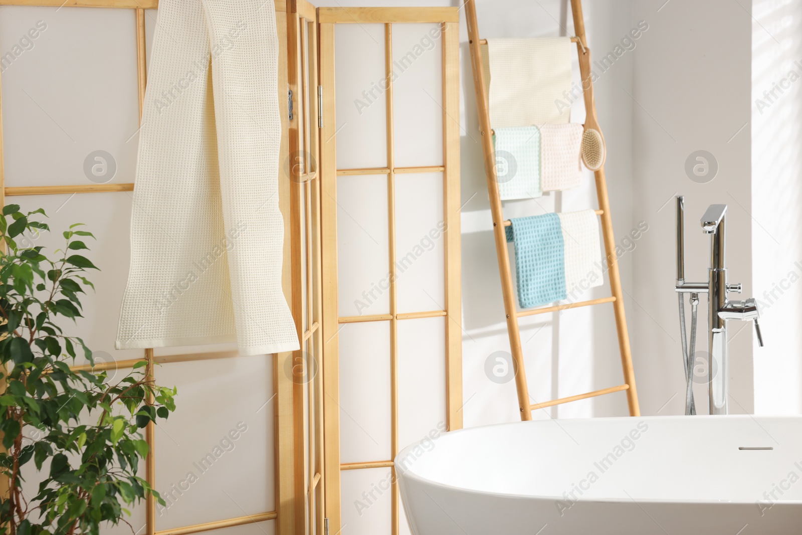 Photo of Fresh clean waffle towels drying in bathroom