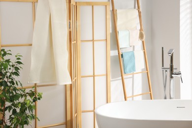 Photo of Fresh clean waffle towels drying in bathroom