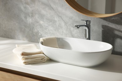 Photo of Clean waffle towels near sink in bathroom
