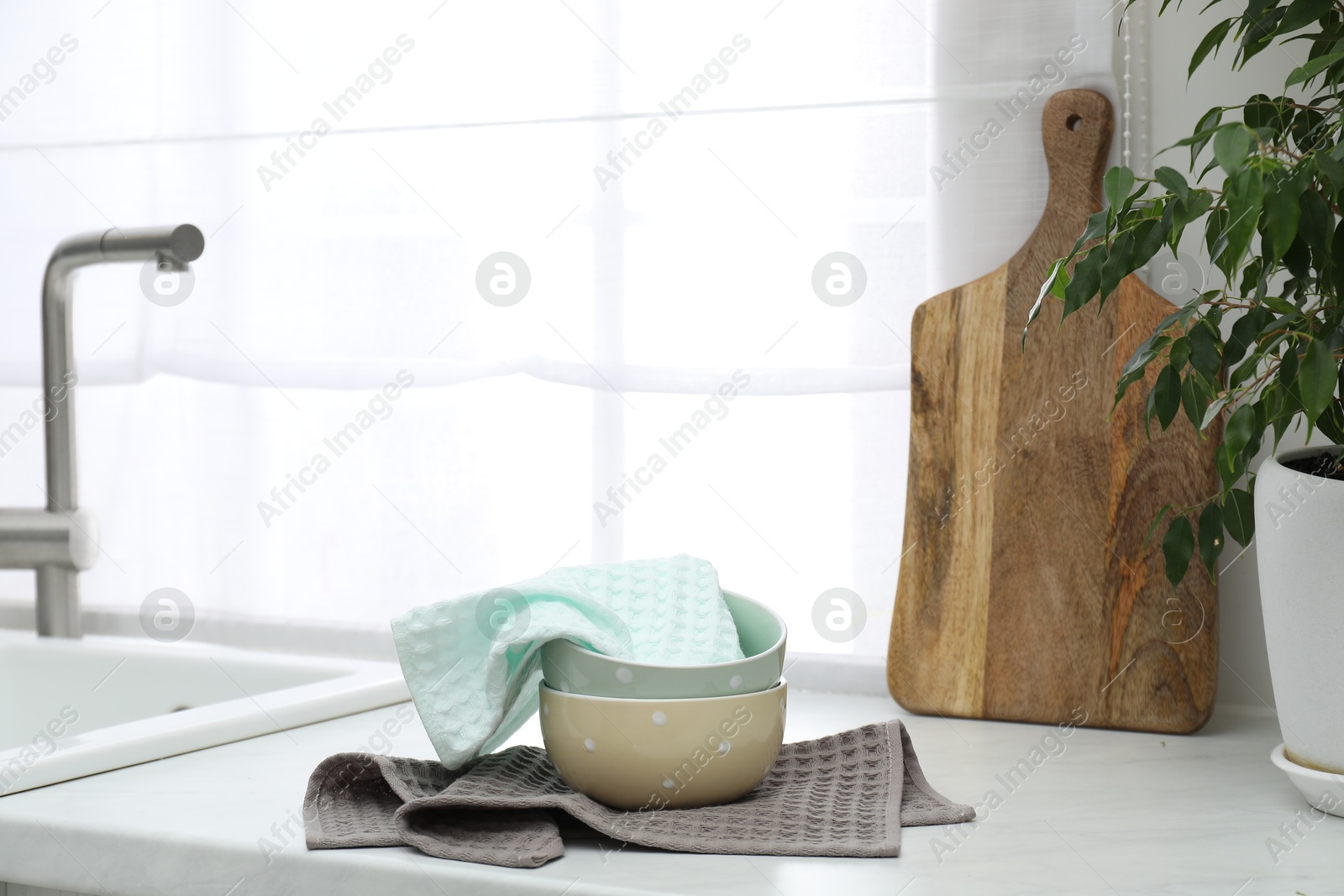 Photo of Clean waffle towels and bowls on countertop in kitchen
