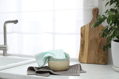 Photo of Clean waffle towels and bowls on countertop in kitchen