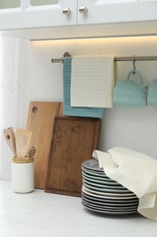 Photo of Clean dishware and waffle towel on countertop in kitchen