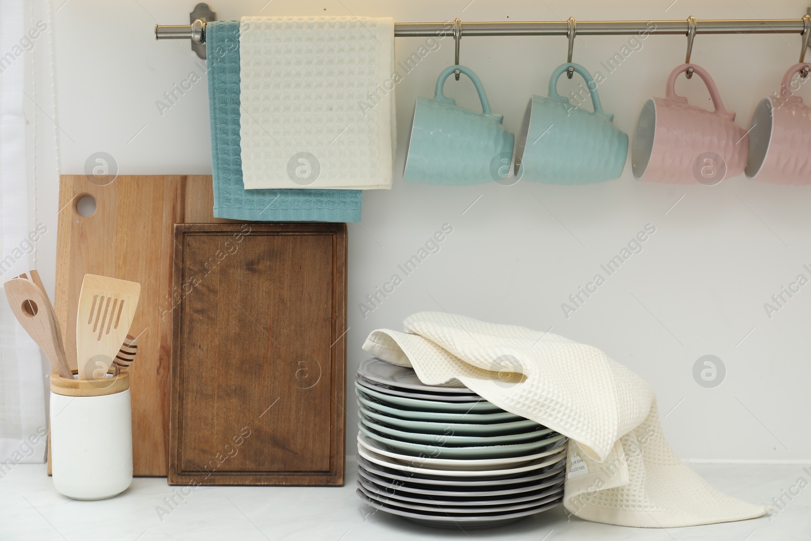 Photo of Clean dishware and waffle towel on countertop in kitchen
