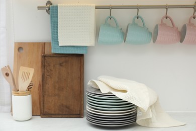 Photo of Clean dishware and waffle towel on countertop in kitchen