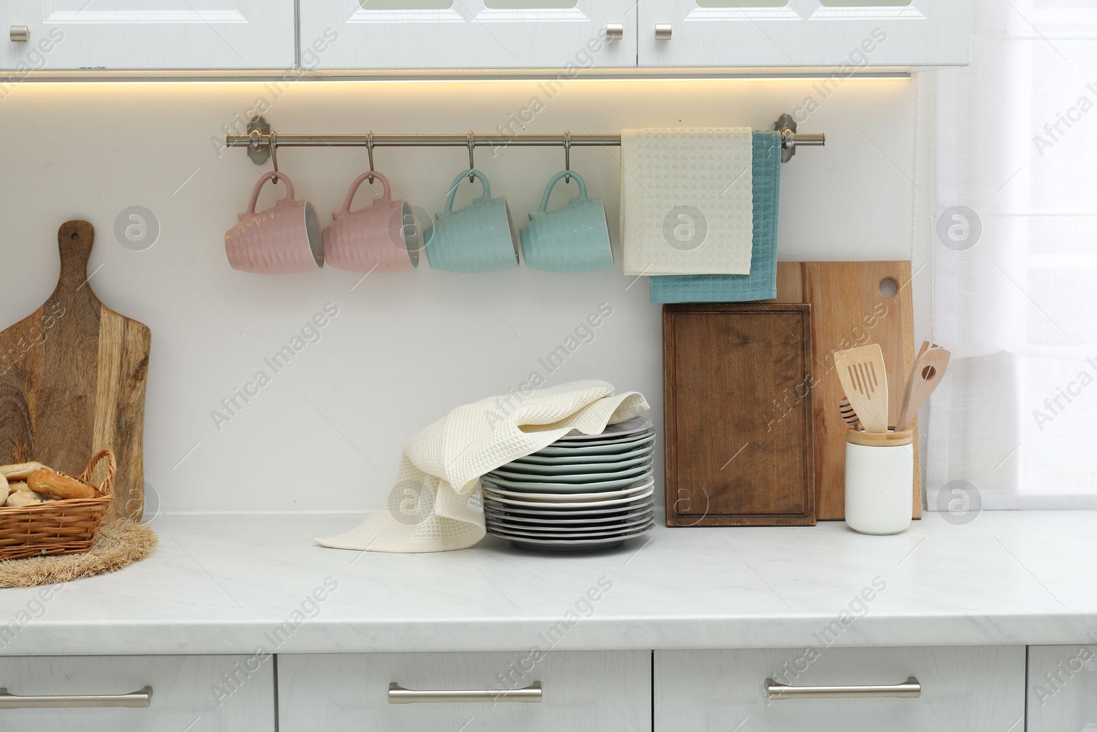 Photo of Clean dishware and waffle towel on countertop in kitchen