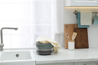 Photo of Clean dishware and waffle towel on countertop in kitchen