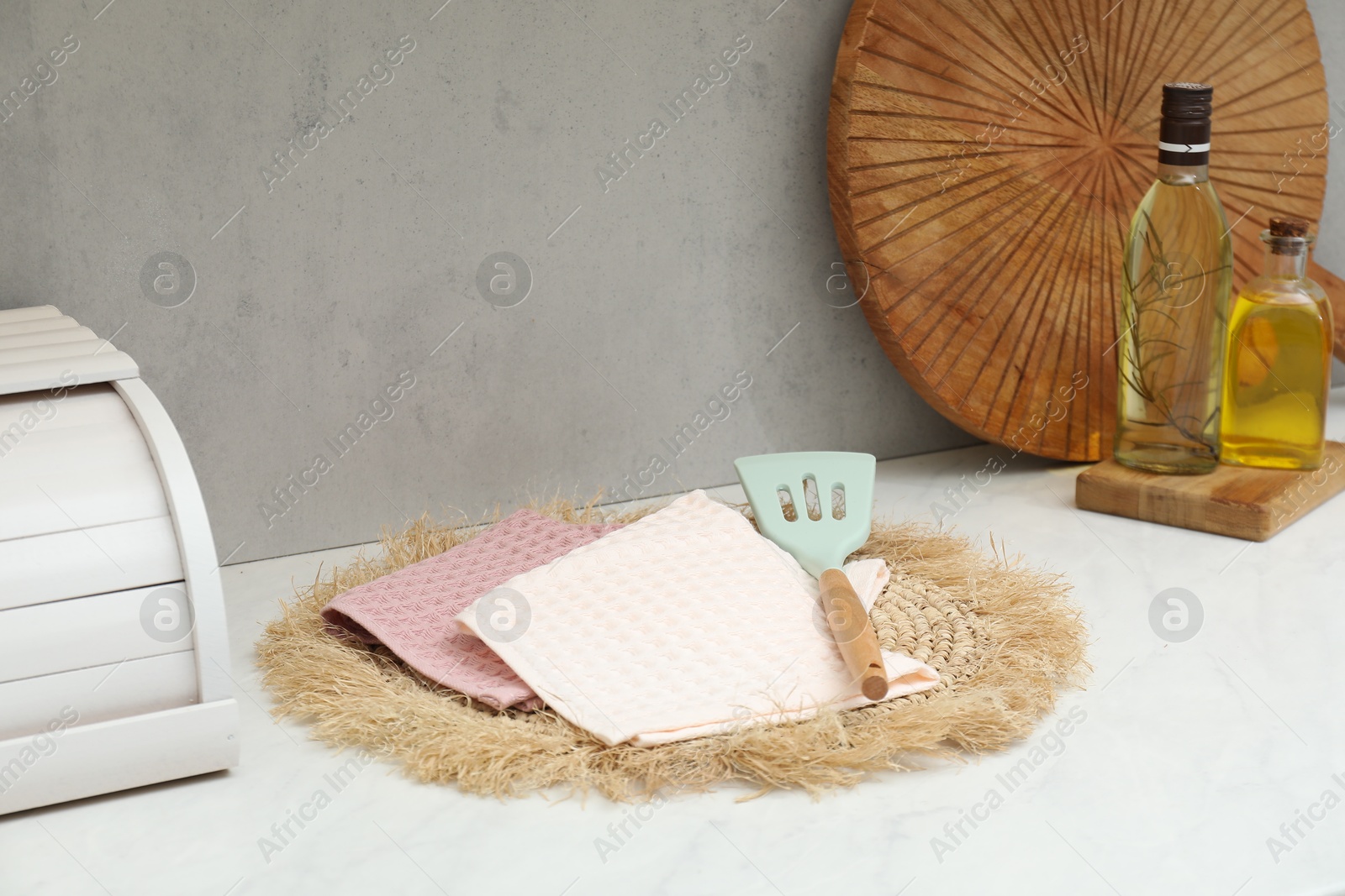 Photo of Clean waffle towels with turner and oil on countertop in kitchen
