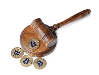 Photo of Cryptocurrency. Bitcoins and judge's gavel isolated on white, above view