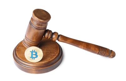 Photo of Cryptocurrency. Bitcoin and judge's gavel isolated on white