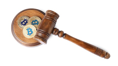 Photo of Cryptocurrency. Bitcoins and judge's gavel isolated on white, above view