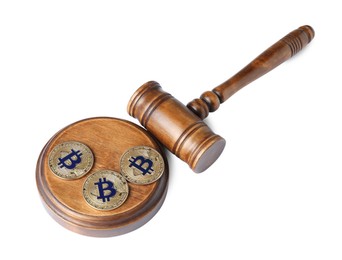 Photo of Cryptocurrency. Bitcoins and judge's gavel isolated on white
